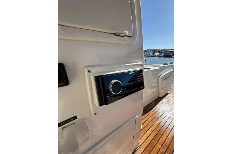 Slide: The Image of 2016 Prestige 500 yacht with Fusion stereo, docked by the water. - 12