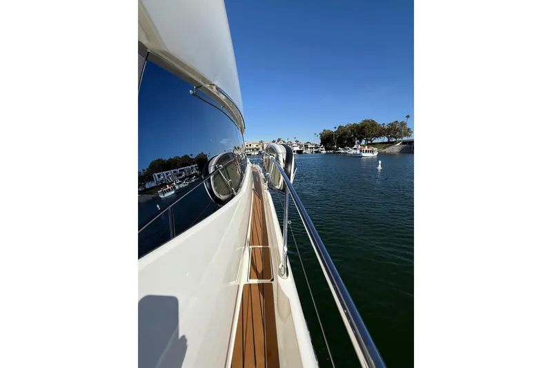 Slide: The Image of Side view of a 2016 Prestige 500 yacht on calm waters, clear blue sky. - 13