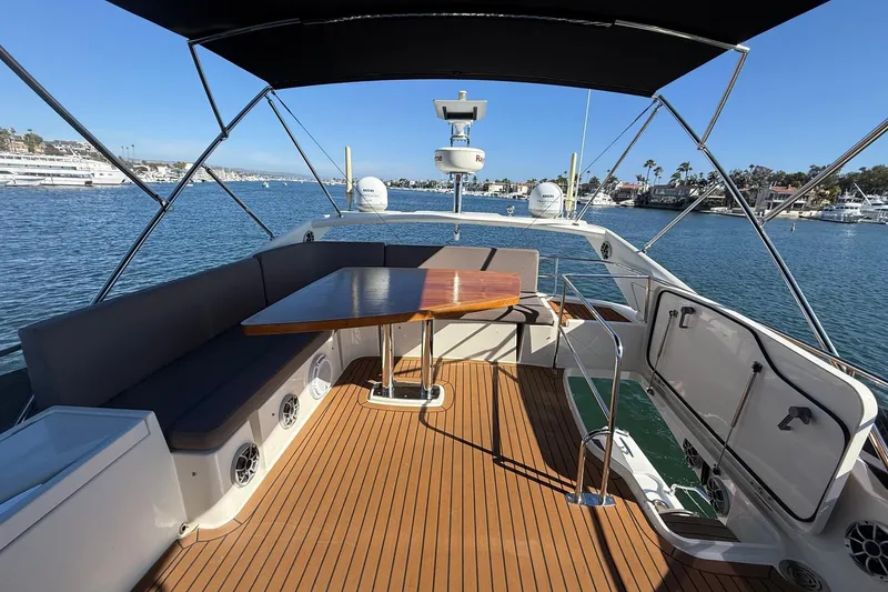 Slide: The Image of 2016 Prestige 500 yacht deck with seating, table, and ocean view. - 19