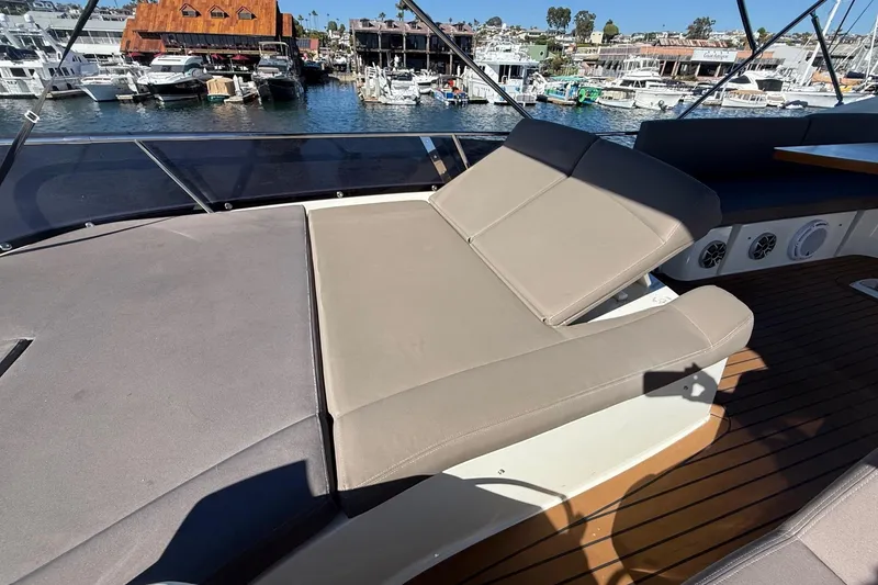 Slide: The Image of Luxurious 2016 Prestige 500 yacht deck with comfortable sun loungers and scenic marina view. - 21