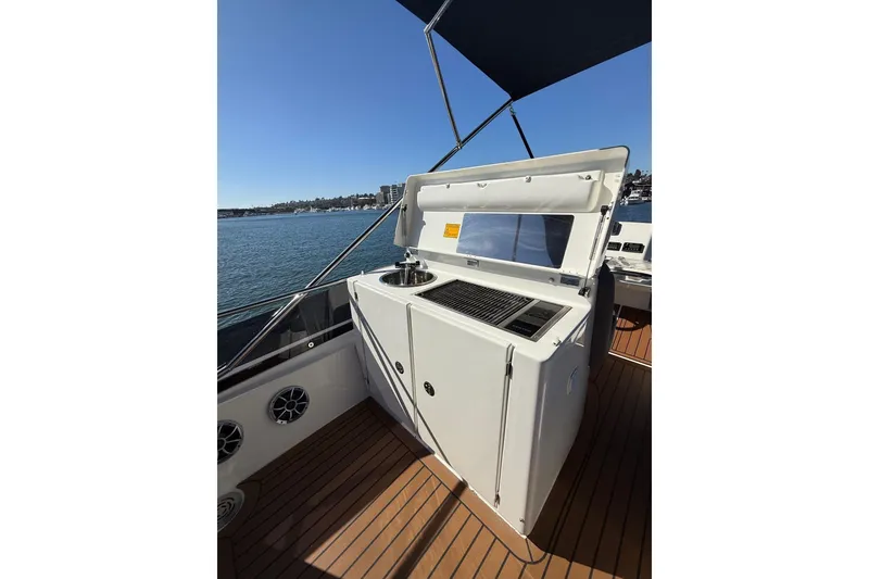 Slide: The Image of Outdoor kitchen on 2016 Prestige 500 yacht with grill and sink, overlooking water. - 22