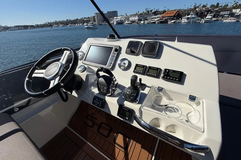 Slide: The Image of Cockpit of 2016 Prestige 500 yacht with steering wheel and navigation controls. - 23