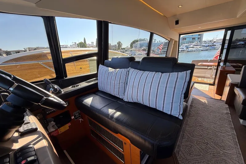 Slide: The Image of Interior of 2016 Prestige 500 yacht with leather seating and marina view. - 31