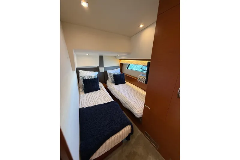 Slide: The Image of Twin cabin interior of 2016 Prestige 500 yacht with modern decor and cozy bedding. - 38