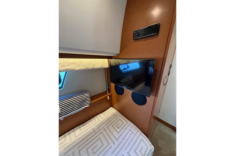 Slide: The Image of 2016 Prestige 500 yacht cabin with TV, bunk bed, and modern decor. - 39