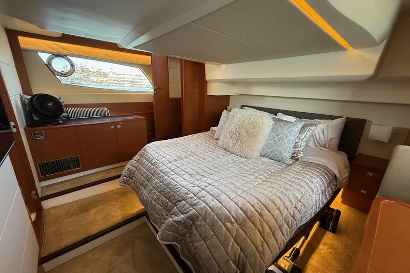 Slide: The Image of Luxurious cabin interior of a 2016 Prestige 500 yacht with plush bedding and elegant decor. - 44