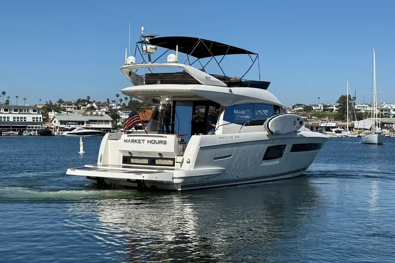 Slide: The Image of Luxury 2016 Prestige 500 yacht cruising in a scenic marina setting. - 5