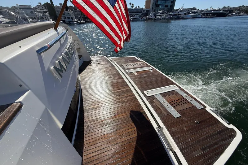Slide: The Image of 2016 Prestige 500 yacht with American flag, docked in a marina. - 7