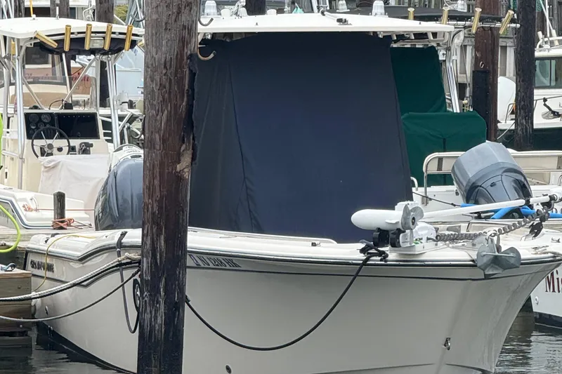 Slide: The Image of 2020 Grady-White Fisherman 257 boat docked, featuring a covered console and outboard motor. - 14