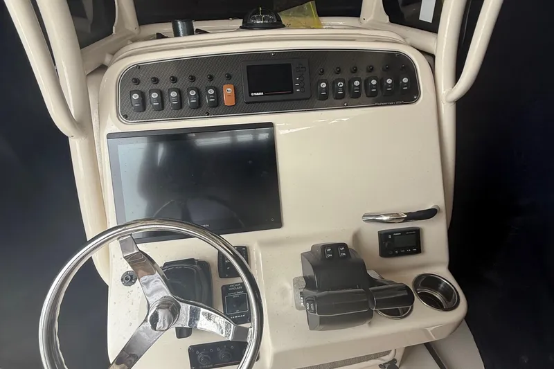 Slide: The Image of Control panel of 2020 Grady-White Fisherman 257 boat with steering wheel and electronic displays. - 24