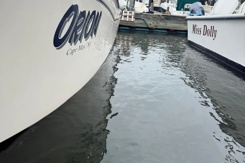 Slide: The Image of Boats "Orion" and "Miss Dolly" docked on calm water, Grady-White Fisherman 257, 2020. - 33