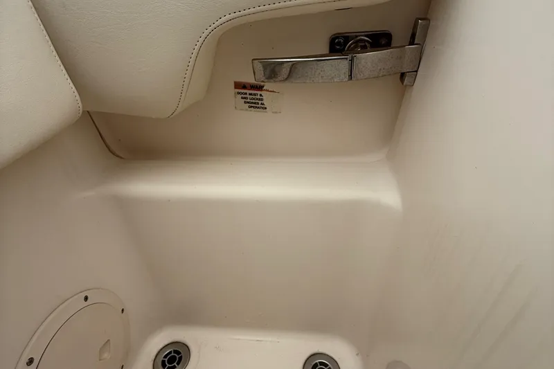Slide: The Image of Interior detail of 2020 Grady-White Fisherman 257 boat, featuring a secure latch and drainage system. - 36