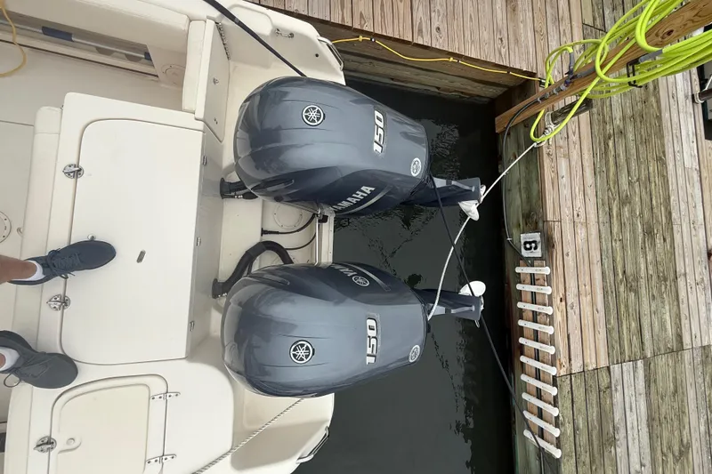 Slide: The Image of 2020 Grady-White Fisherman 257 with twin Yamaha 150 engines docked at a wooden pier. - 39