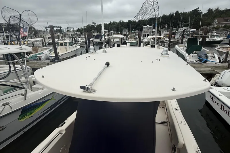 Slide: The Image of 2020 Grady-White Fisherman 257 boat docked at a marina with fishing nets visible. - 47