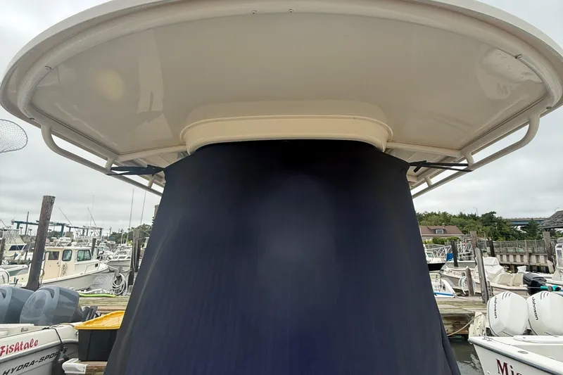 Slide: The Image of 2020 Grady-White Fisherman 257 boat docked at a marina, featuring a covered console. - 48