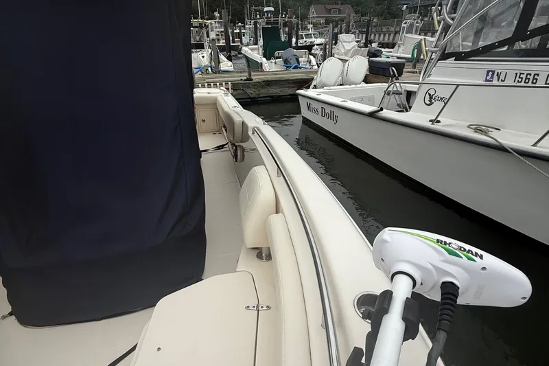 Slide: The Image of 2020 Grady-White Fisherman 257 boat docked, featuring a Rhodan trolling motor. - 53