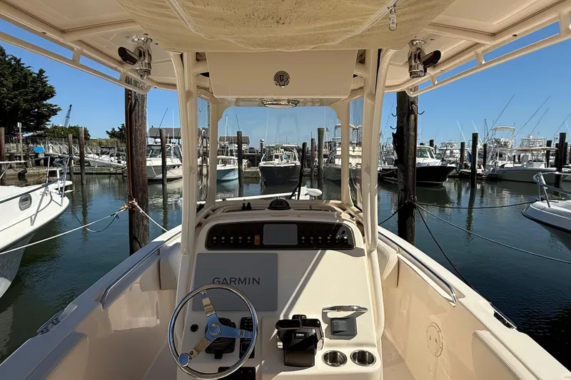 Slide: The Image of 2020 Grady-White Fisherman 257 boat interior at marina, featuring Garmin navigation system. - 55