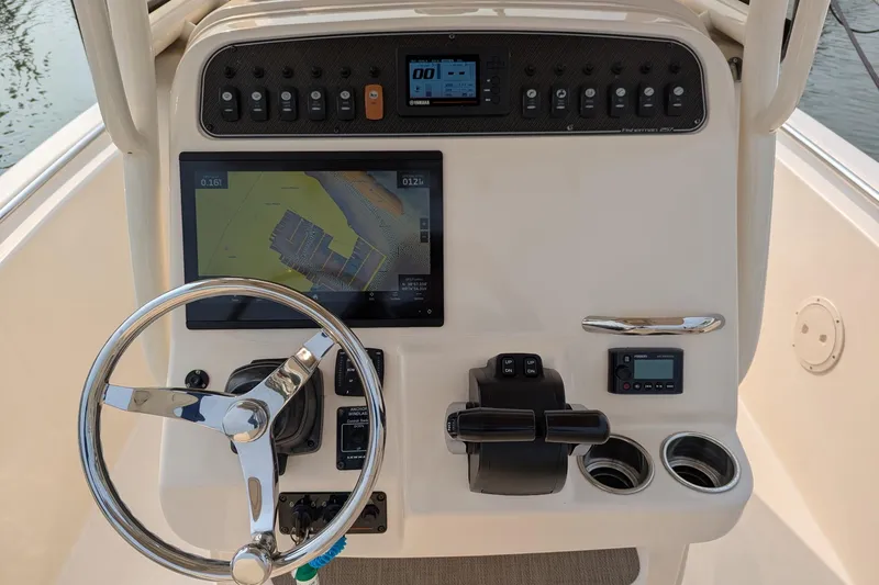 Slide: The Image of 2020 Grady-White Fisherman 257 helm with navigation display and controls. - 58