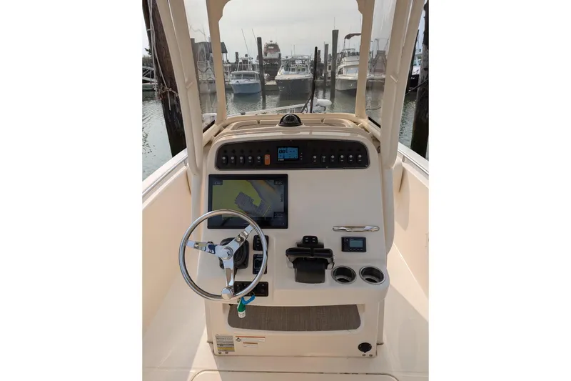 Slide: The Image of 2020 Grady-White Fisherman 257 boat console with steering wheel and navigation display. - 59