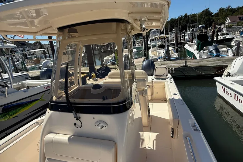 Slide: The Image of 2020 Grady-White Fisherman 257 boat docked at a marina, surrounded by other vessels. - 62