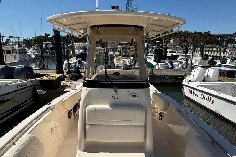 Slide: The Image of 2020 Grady-White Fisherman 257 boat docked at a marina, surrounded by other vessels. - 65