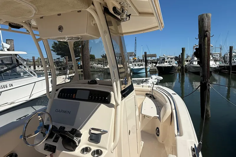 Slide: The Image of 2020 Grady-White Fisherman 257 boat docked at marina, featuring Garmin navigation system. - 67