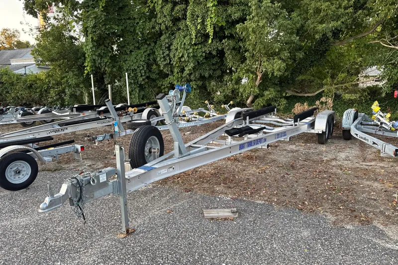 Slide: The Image of Boat trailers parked on gravel, surrounded by trees, suitable for Grady-White Fisherman 257. - 69