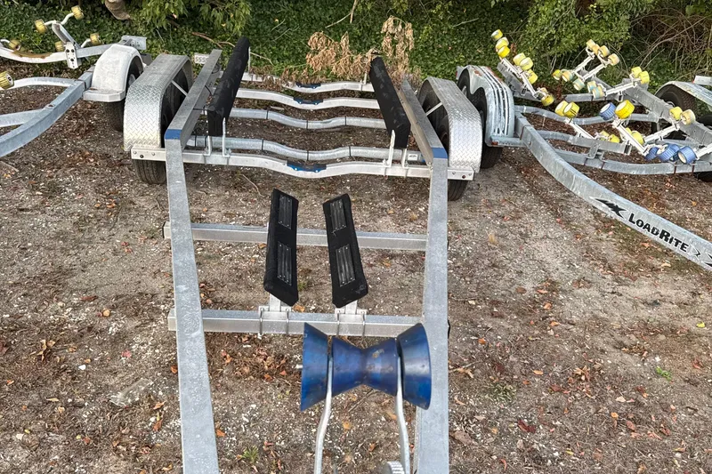 Slide: The Image of Boat trailer for 2020 Grady-White Fisherman 257, parked on gravel with greenery background. - 70