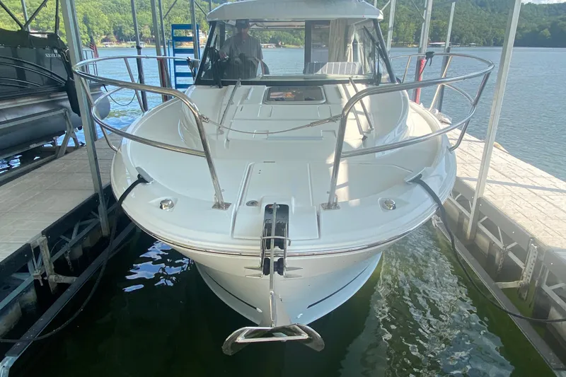 Slide: The Image of 2024 Jeanneau NC 895 boat docked on a serene lake. - 13