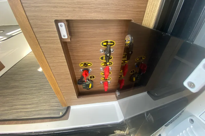 Slide: The Image of Control panel inside 2024 Jeanneau NC 895 boat, featuring switches and labels. - 16