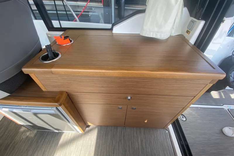 Slide: The Image of 2024 Jeanneau NC 895 interior with wooden cabinetry and compact design. - 18