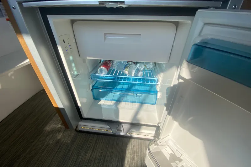 Slide: The Image of Open fridge on Jeanneau NC 895 boat, stocked with beverages, 2024 model. - 21