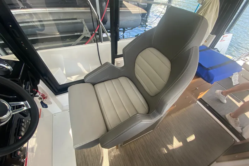 Slide: The Image of Captain's seat in 2024 Jeanneau NC 895 boat, featuring modern design and comfortable upholstery. - 25