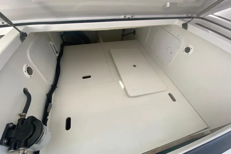 Slide: The Image of 2024 Jeanneau NC 895 storage compartment with white interior and access panels. - 28