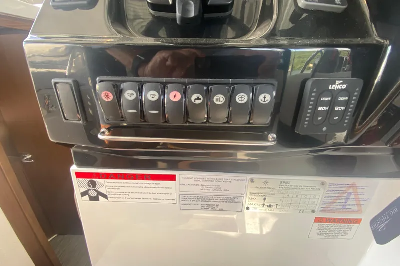 Slide: The Image of Control panel of 2024 Jeanneau NC 895 boat with labeled switches and warnings. - 31