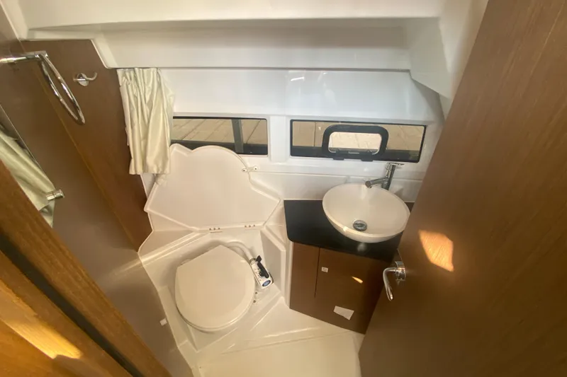 Slide: The Image of 2024 Jeanneau NC 895 bathroom with modern sink, toilet, and window. - 36