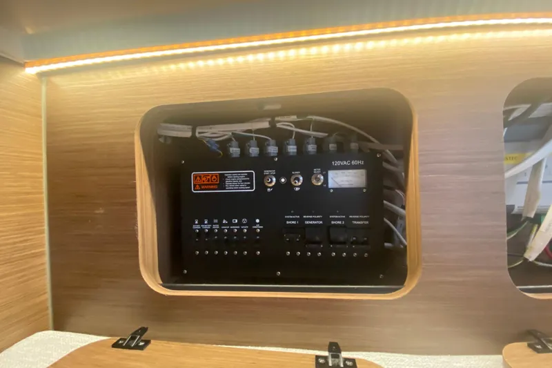 Slide: The Image of Electrical panel inside 2024 Jeanneau NC 895 boat, featuring switches and wiring. - 41