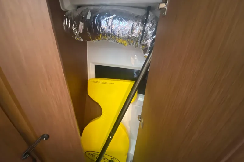 Slide: The Image of Interior view of 2024 Jeanneau NC 895 boat, featuring storage compartment and ventilation duct. - 42