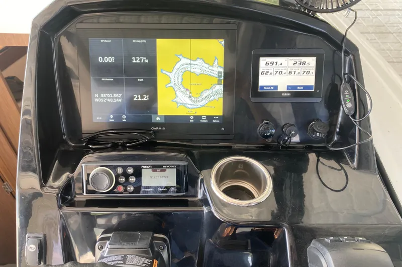 Slide: The Image of 2024 Jeanneau NC 895 helm with Garmin navigation display and controls. - 44