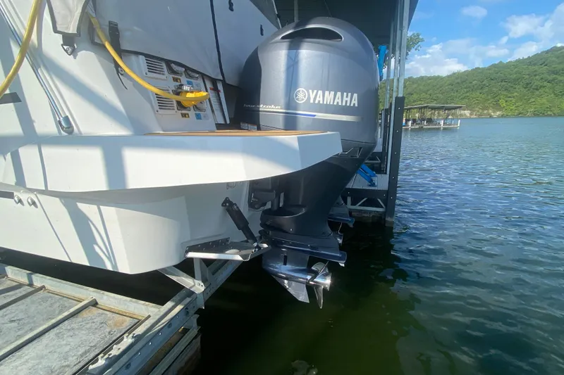 Slide: The Image of 2024 Jeanneau NC 895 with Yamaha outboard motor docked on a sunny day. - 8