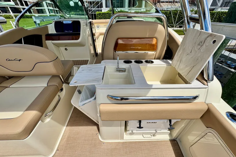 Slide: The Image of 2023 Chris-Craft Calypso 28 interior with luxurious seating and built-in sink. - 11