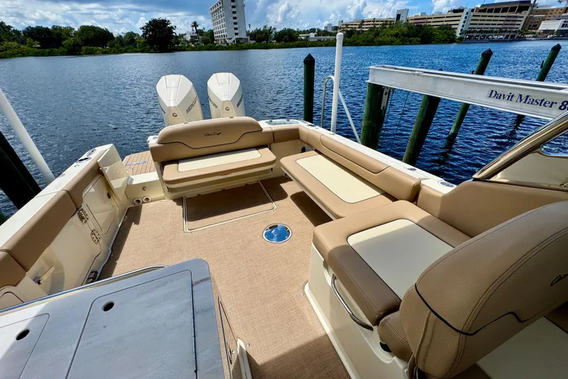 Slide: The Image of 2023 Chris-Craft Calypso 28 boat interior with seating and twin Mercury engines. - 13