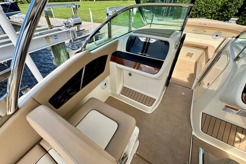 Slide: The Image of 2023 Chris-Craft Calypso 28 interior with beige seating and elegant design. - 16