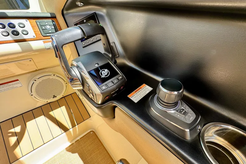 Slide: The Image of 2023 Chris-Craft Calypso 28 boat controls with joystick and throttle in cockpit. - 22