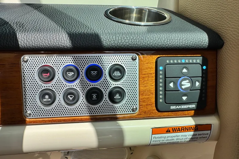 Slide: The Image of Control panel of 2023 Chris-Craft Calypso 28 boat with Seakeeper system and warning label. - 23
