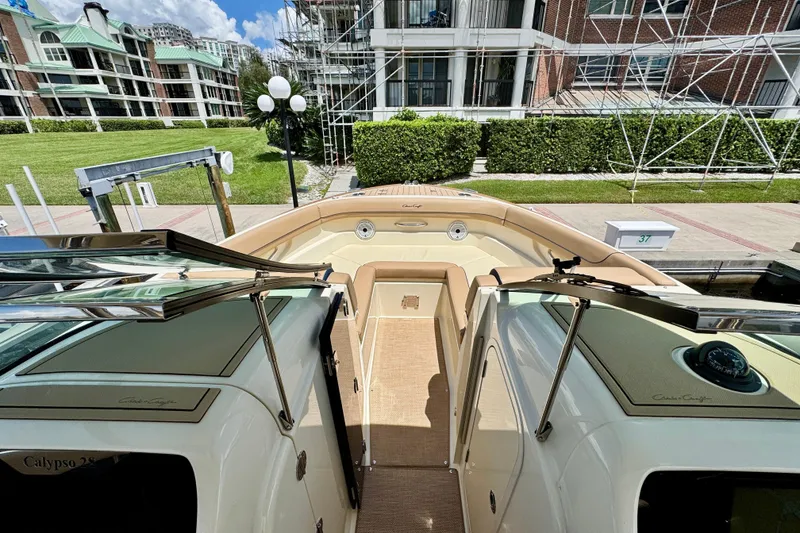 Slide: The Image of 2023 Chris-Craft Calypso 28 boat docked, showcasing elegant interior and modern design. - 24