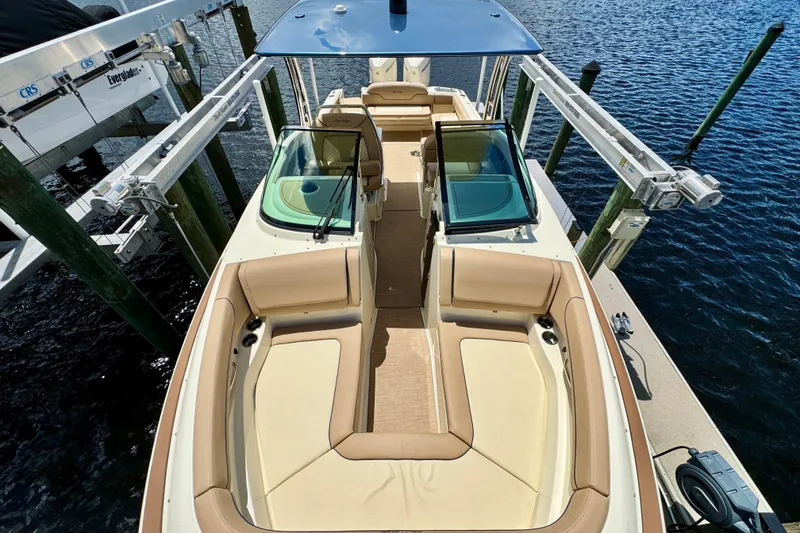 Slide: The Image of 2023 Chris-Craft Calypso 28 boat with spacious seating, docked by the water. - 27