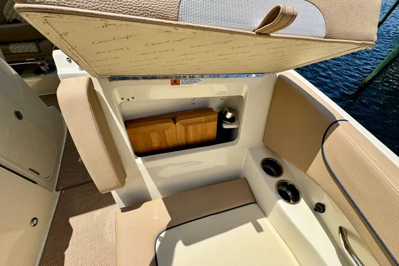 Slide: The Image of 2023 Chris-Craft Calypso 28 boat interior with storage compartment and cup holders. - 29