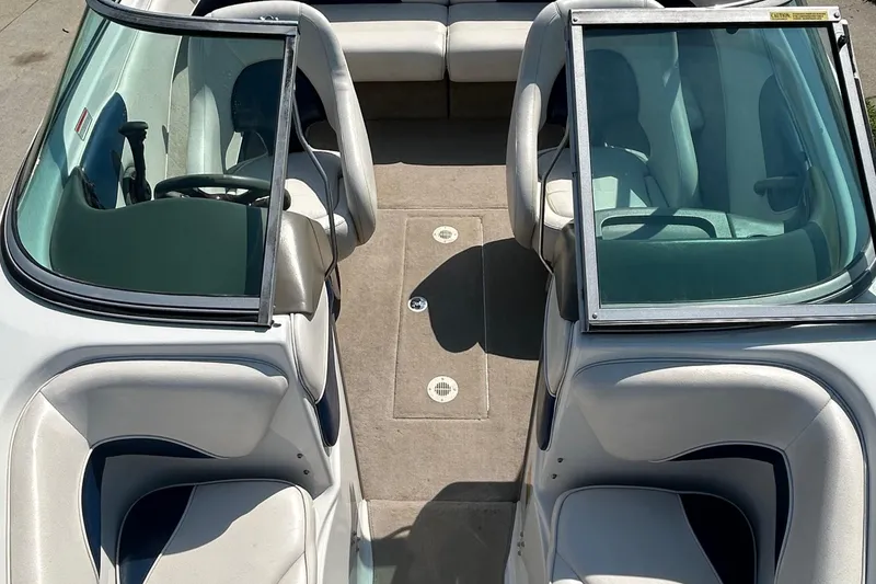 Slide: The Image of 2003 Crownline 192 BR boat interior with open windshield and seating arrangement. - 10