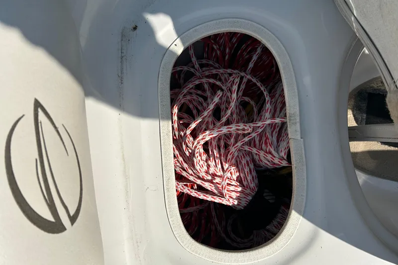 Slide: The Image of Storage compartment with red and white rope on a 2003 Crownline 192 BR boat. - 11